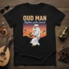 Oud Man Rhythm of the Desert t-shirt with a dancing man in traditional attire, desert sunset background, and Arabic text