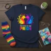 Navy t-shirt with "Our love is our PRIDE" text and two colorful cats in a rainbow design