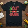 T-shirt with "Out of 1st Grade" text, peace sign, apple, and books graphic