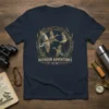Vintage OUTDOOR ADVENTURES EST. 1920 t-shirt design with flying mallard ducks and reeds, navy blue shirt