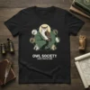 Black t-shirt featuring the "Owl Society Night Protectors" text and a central owl graphic surrounded by smaller owl icons