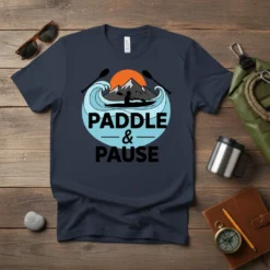 Paddle & Pause kayaking t-shirt design featuring a silhouette of a kayaker on waves with mountains and sun