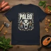 Paleo Diet T-Shirt featuring the word PALEO in bold, surrounded by ancient figures, a skull, and natural elements