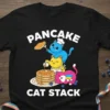 Pancake Cat Stack T-Shirt featuring three cute cats building a pancake tower with syrup and blueberries