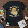 Pancakes Panic Attacks text with stack of pancakes on a brain graphic, yellow lightning bolts, on a navy t-shirt