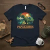 Papasaurus t-shirt with T-Rex and baby dinosaur graphic, set against a sunset and jungle background
