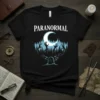Black t-shirt with "PARANORMAL" text, zombie hands rising from a forest, moon, and a tombstone with 'R'