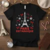 Black t-shirt with "Paris Est Magique" text and Eiffel Tower graphic surrounded by snowflakes and red bows