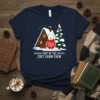 Part of the Cozy Cabin Crew t-shirt design with a polar bear in a red sweater, A-frame cabin, and snowy