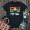 Retro sunset beach design with 'Pattaya Thailand' text, palm trees, boat, and city skyline