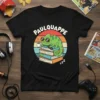 Paulquappe text above a green chameleon sitting on books with a coffee cup, wearing sunglasses. Retro sunset background