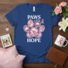 Paws For Hope paw print design with pink ribbons and lotus flowers, on a blue t-shirt
