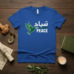 Blue t-shirt with "سلام PEACE" in Arabic and English, featuring a green dove holding an olive branch