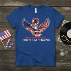 Peace Love America T-Shirt with patriotic eagle, American flag wings, and sunflower detail. Text reads "Happy Independence Day Peace Love