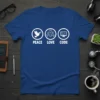 Blue t-shirt with white "Peace Love Code" graphic, featuring icons for peace, love, and coding