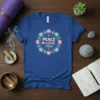 Peace Love Yoga text graphic with floral mandala design on a blue t-shirt