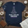 Peace Love and Smudge t-shirt with a meditating cat graphic and purple halo. Features the website smudginator.com
