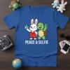 Peace & Selfie t-shirt design with a cartoon bunny and turtle taking a selfie, white text