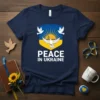 Navy blue t-shirt with "PEACE IN UKRAINE" text and a crest featuring doves and Ukrainian flag colors