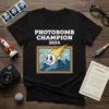Black t-shirt with "PHOTOBOMB CHAMPION 2024" text and a cartoon comet character in a picture frame graphic