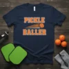 Pickle Baller text with a pickleball graphic on a navy t-shirt, perfect for pickleball players