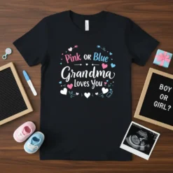 Pink or Blue Grandma Loves You text design with hearts and baby-themed graphics on a black t-shirt