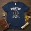 Pirates With A Heart T-Shirt featuring a white pirate ship graphic with skull and crossbones flags and text "Pirates With