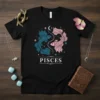 Black t-shirt with a Pisces zodiac symbol featuring two intertwined fish, moon, and stars in blue and pink tones