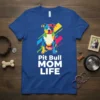 Pit Bull MOM LIFE text with a colorful artistic pit bull illustration on a royal blue t-shirt
