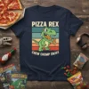 Pizza Rex Chew Chomp Enjoy t-shirt design with a green cartoon T-Rex eating pizza, retro stripes, and bold text