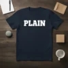 Navy blue t-shirt with bold white text reading "PLAIN" for minimalist design enthusiasts