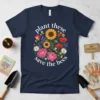 Plant These Save The Bees t-shirt with a circular floral design featuring sunflowers, poppies, peonies, daisies, lavender, and bumblebees