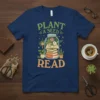 Plant a Seed Read quote on a navy t-shirt with a jar graphic containing books and plants