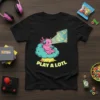 Black t-shirt featuring a pink axolotl wearing headphones and playing a video game, with text "PLAY A LOTL" below