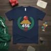 Navy t-shirt with the number 456 in white, surrounded by a laurel wreath, coins, a red crystal ball, and a