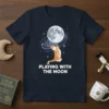 Orange tabby cat reaching for the moon with "PLAYING WITH THE MOON" text on a navy t-shirt