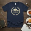 Navy t-shirt with "Pleasant Company" text inside a laurel wreath, featuring a coffee cup, open book, and feather