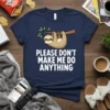 Navy t-shirt with a cartoon sloth hanging from a branch and the text "PLEASE DON'T MAKE ME DO ANYTHING" in