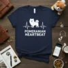 Pomeranian Heartbeat T-Shirt featuring a white silhouette of a Pomeranian within a heartbeat line graphic and the text "POMERANIAN HEARTBEAT"
