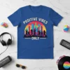 Positive Vibes Only t-shirt with a colorful city skyline graphic and dancing silhouettes