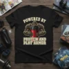 Black t-shirt with "Powered By Protein And Plot Armor" text and knight holding a protein shaker graphic