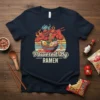 Powered By RAMEN T-Shirt design featuring a red demon eating ramen with chopsticks and a retro sunset background