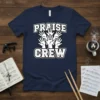 Navy t-shirt with white and black text "Praise Crew" and raised hands graphic, representing a worship team