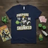Prepare to be Skunked t-shirt design with a crowned skunk spraying green mist. Features bold yellow and white text