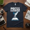 Navy t-shirt with "PRESS INDEPENDENT JOURNALISM" text and a quill pen on a radio tower above an open book graphic