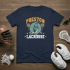 Navy blue t-shirt featuring "PRESTON LACROSSE" text with a lacrosse player graphic and crossed sticks