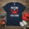 Navy t-shirt with white text "PRETEND I'M A CRAB" and a cartoon crab wearing a crown graphic