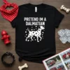 Pretend I'm a Dalmatian text and graphic on a black t-shirt, featuring a white Dalmatian dog illustration surrounded by white
