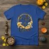 Pretty Like Oshun text design with gold floral wreath and lotus flowers on a royal blue t-shirt