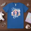 Blue t-shirt with "Princess Chloe" in white script, a pink castle, rainbow, and clouds design